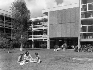 Students talking on the grass at A Block